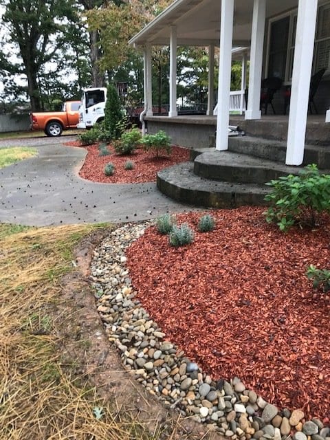 red mulch placed in beds with new plants